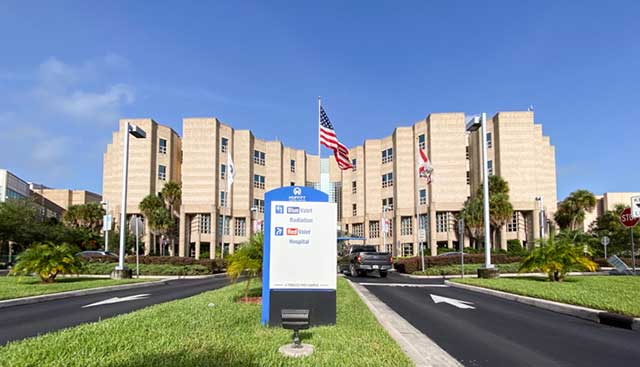 Moffitt Cancer Center with a flag flying at the front of the hospital