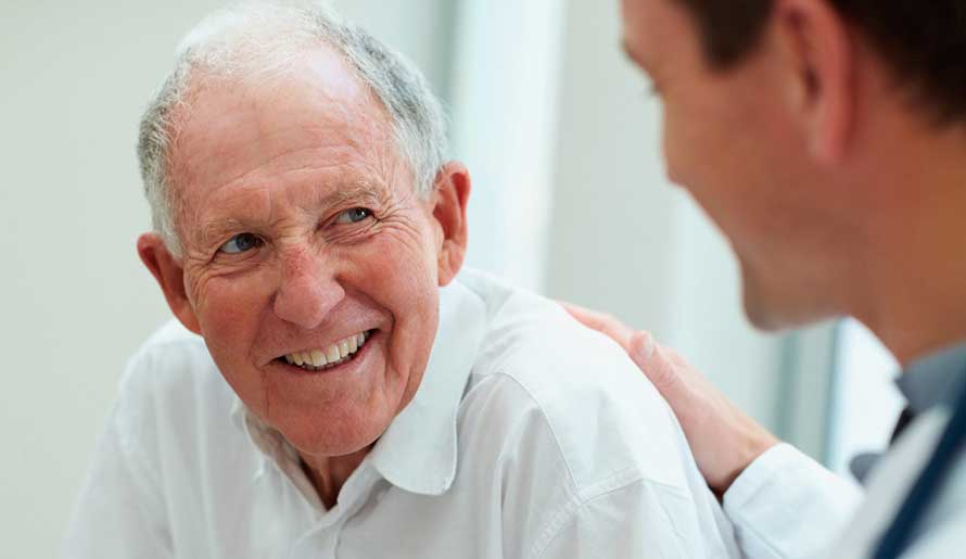 Older male patient speaking with doctor