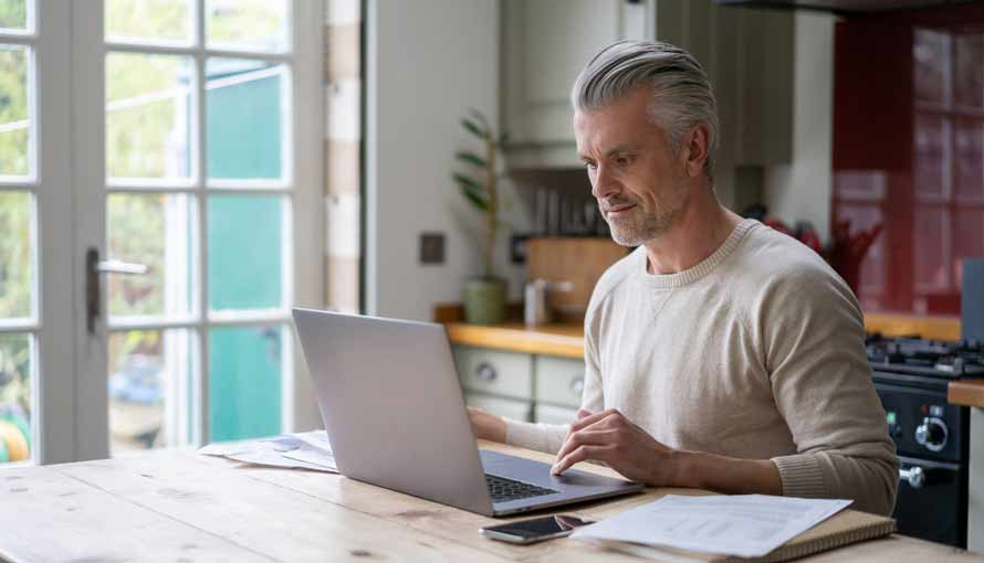 man working at home searching for information about what causes leukemia