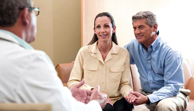 patients speakign with doctor while sitting on couch