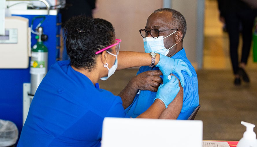 A man receiving a COVID vaccine