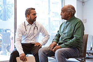 Man discussing penile cancer with patient