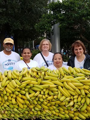 Volunteers prepare fruit refreshments during the 2018 Miles for Moffitt 