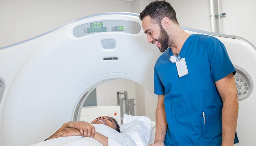 a technician checking on a myeloid sarcoma patient before they enter CT scan machine