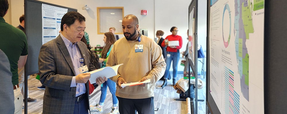 Dr. Patrick Hwu reads document about catchment area
