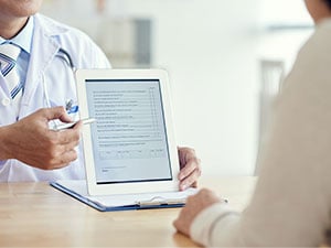 Doctor showing notes on tablet