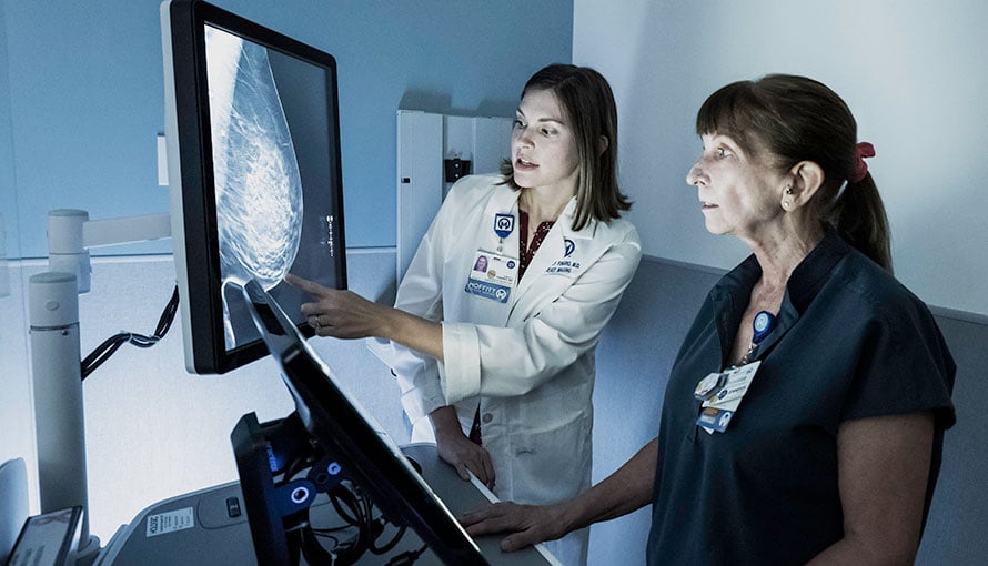 A doctor reviewing a breast scan