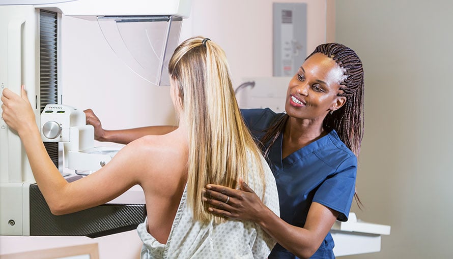 Woman in mammogram machine at Moffitt