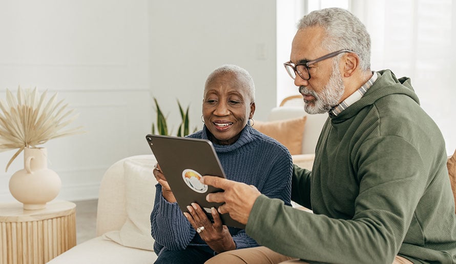 Couple looking at Medicare options on iPad