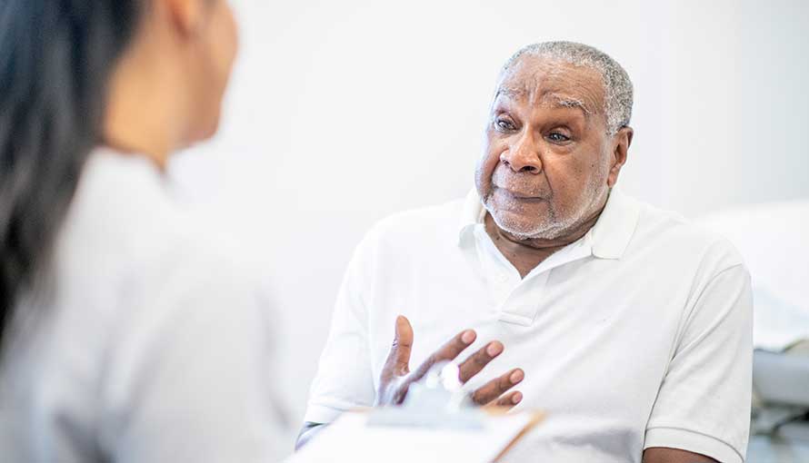 Prostate cancer patient discussing radiation with nurse