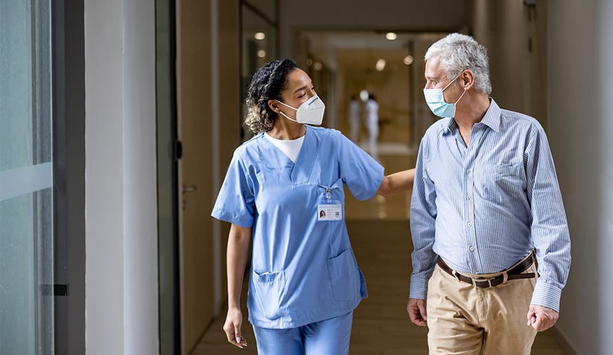 Nurse walking with lymphoma patient in hospital