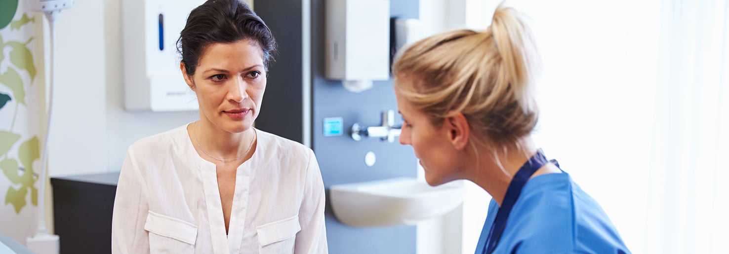 Female patient discusses uterine fibroid embolization with a nurse