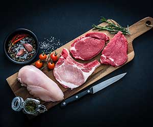 red meat and poultry on a cutting board