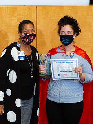 Kalie Craven, RN, 2021 Excellence in a Unique Role Award Winner, pictured with a Moffitt nurse
