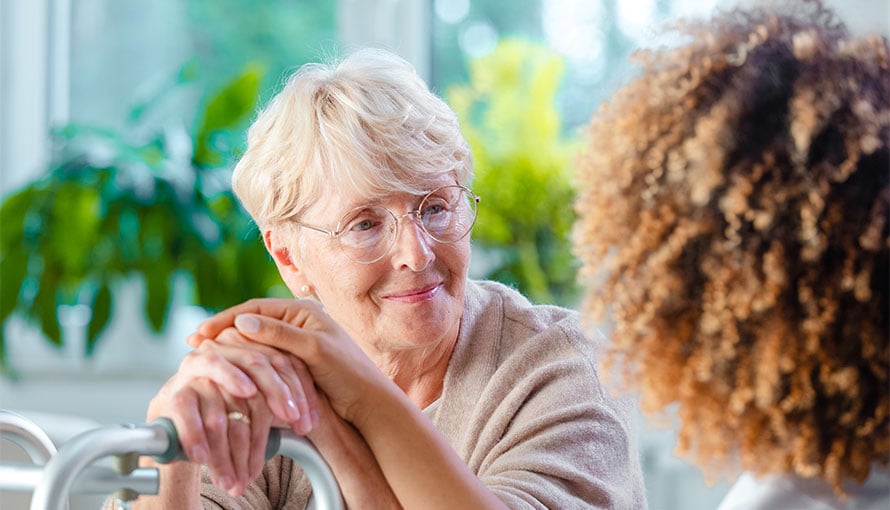 Older female patient listening to nurse