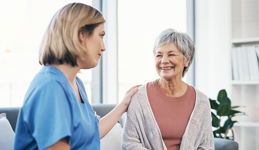 Nurse speaking with older female patient