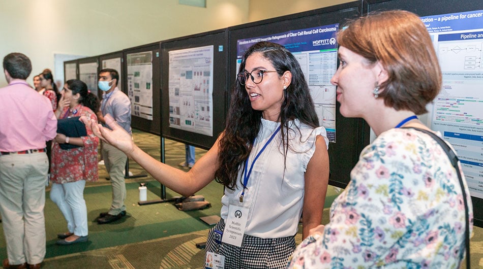 Postdocs review their poster at the Scientific Symposium