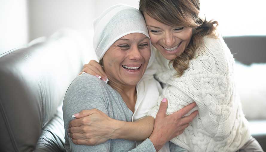 A friend hugs a cervical cancer patient