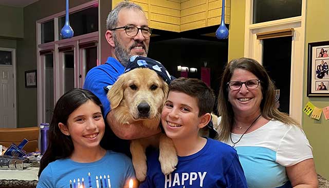 Moffitt patient David posing with his family for his daughter's birthday and Chanukah celebration