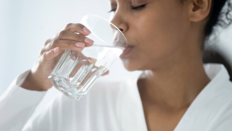 Woman with bladder cancer metastasis drinking water