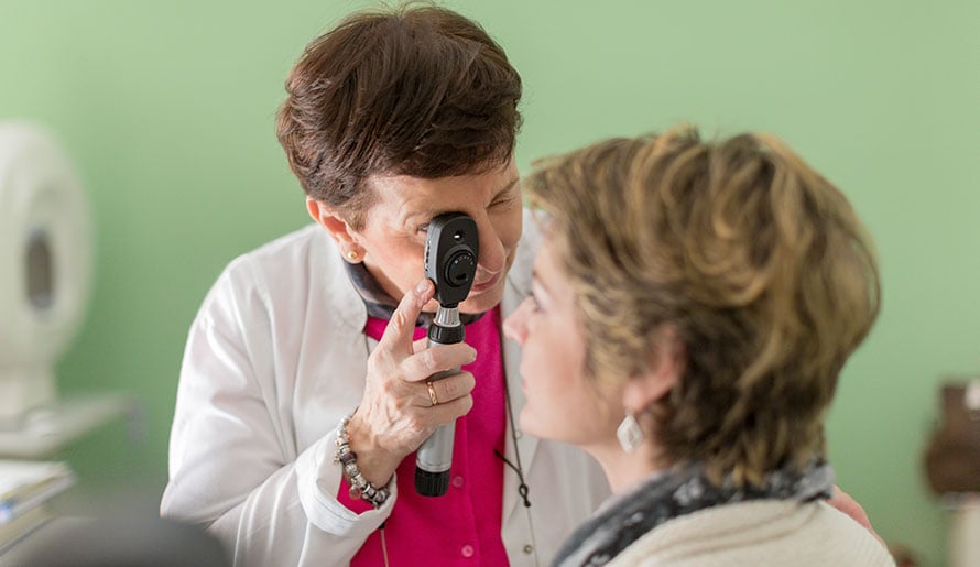Woman getting her eyes checked by an ocologist