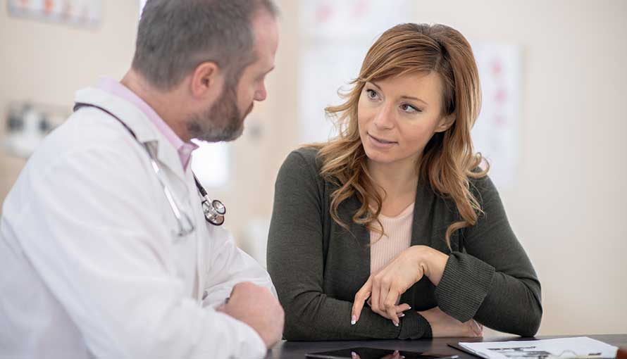 Female patient discussing her treatment with her doctor