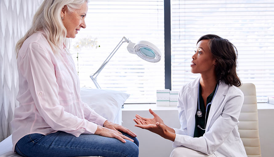 A doctor talks to a female patient