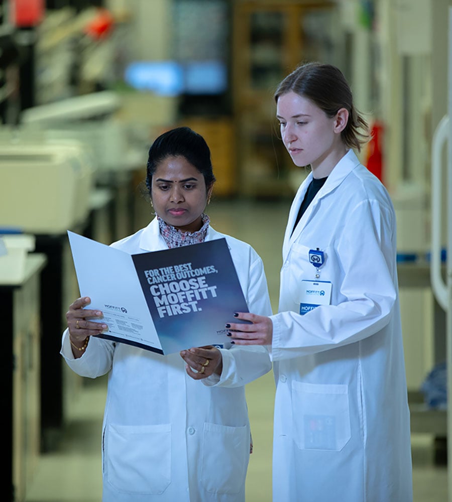 Moffitt researchers reading brochure
