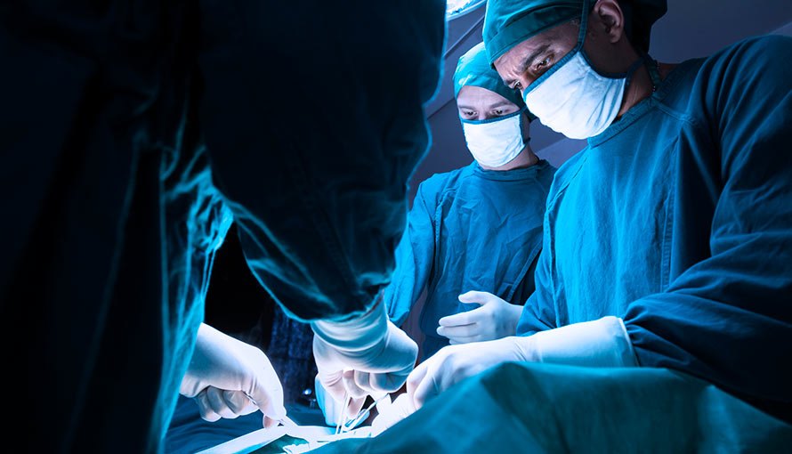 Doctors performing a spinal tumor surgery