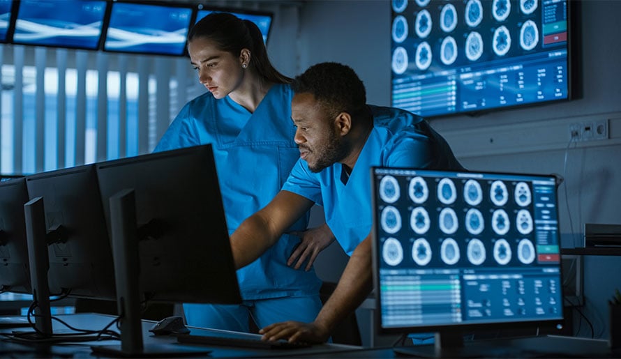 Neurosurgeons looking at brain scan