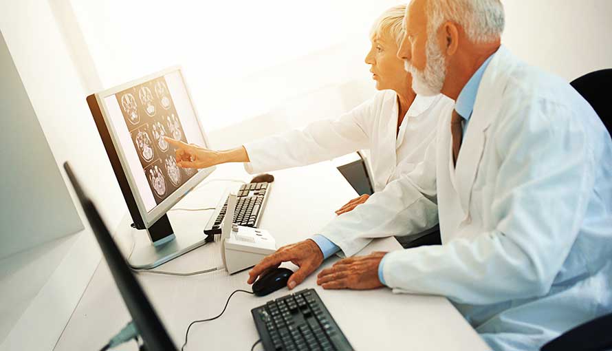 Doctors looking a scans on computer