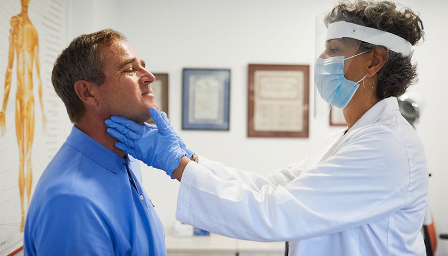 Doctor checking patient for oral cancer symptoms
