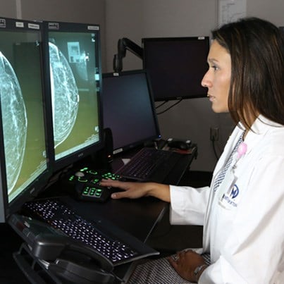 female physician inspecting types of Breast Cancer Clearwater FL