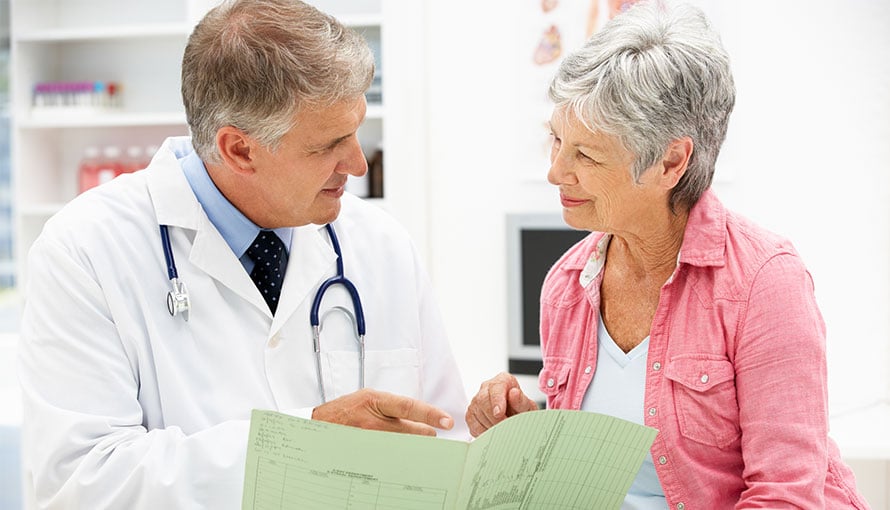 Doctor reviews breast cancer clinical trials with patient