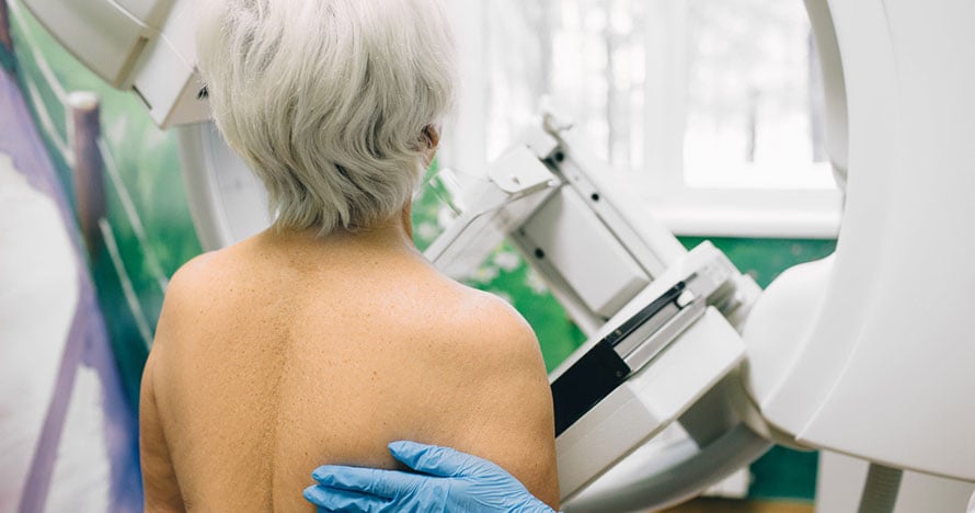 senior woman in mammography machine