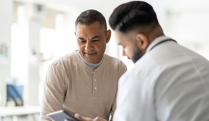 Patient looking at prostate biopsy results with doctor