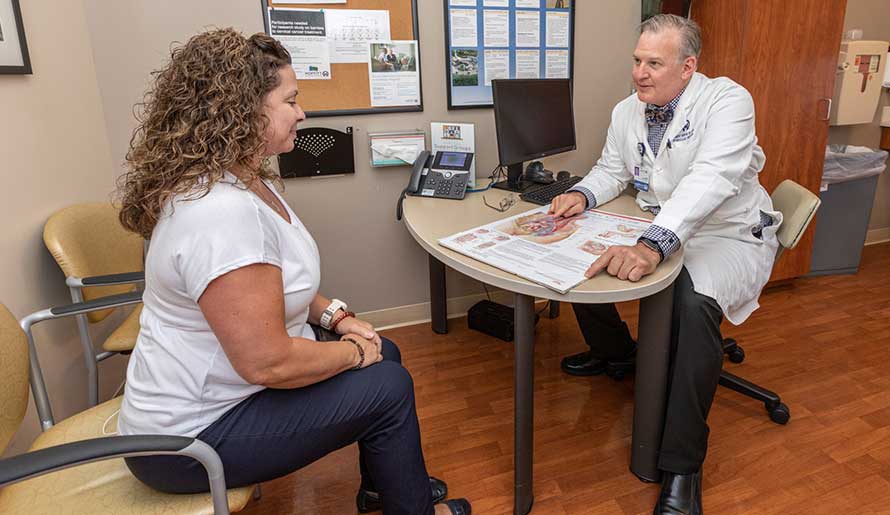 Dr. Robert Wenham speaks with a patient about ovarian cancer