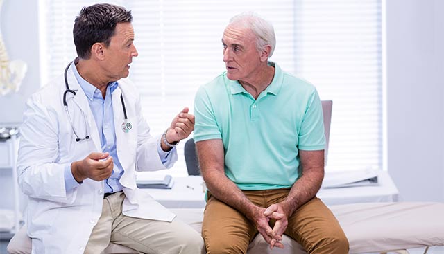 Doctor talking with a male patient about leukemia