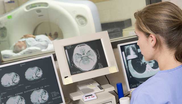 tech looking at lung scans