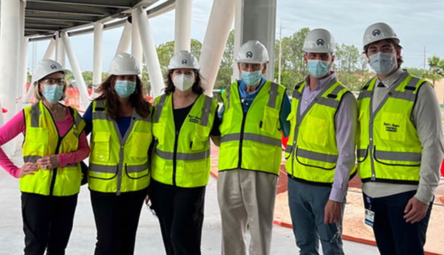 Construction team wearing reflective vests and hard hats at the new Moffitt McKinley Hospital