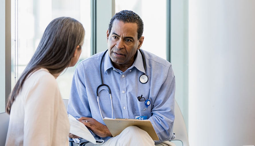 Doctor discussing multiple myeloma symptoms with patient.