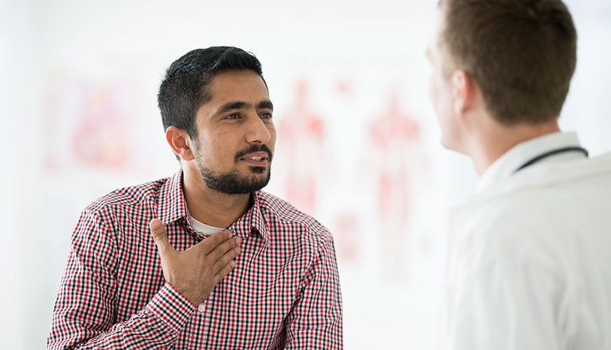 Patient pointing to pain in his throat