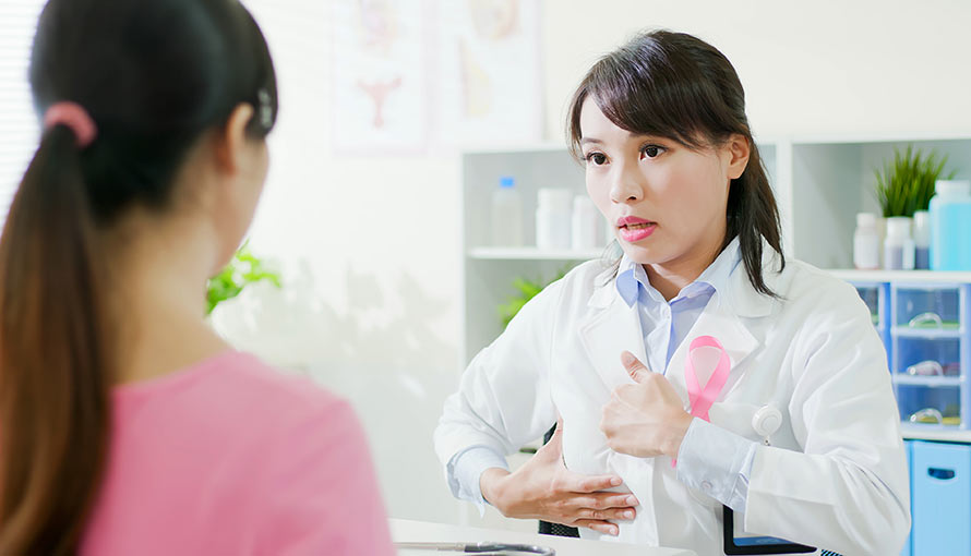 A doctor shows a patient how to do a breast self-exam
