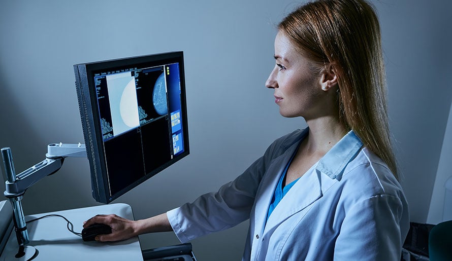 Radiologist reviewing mammogram