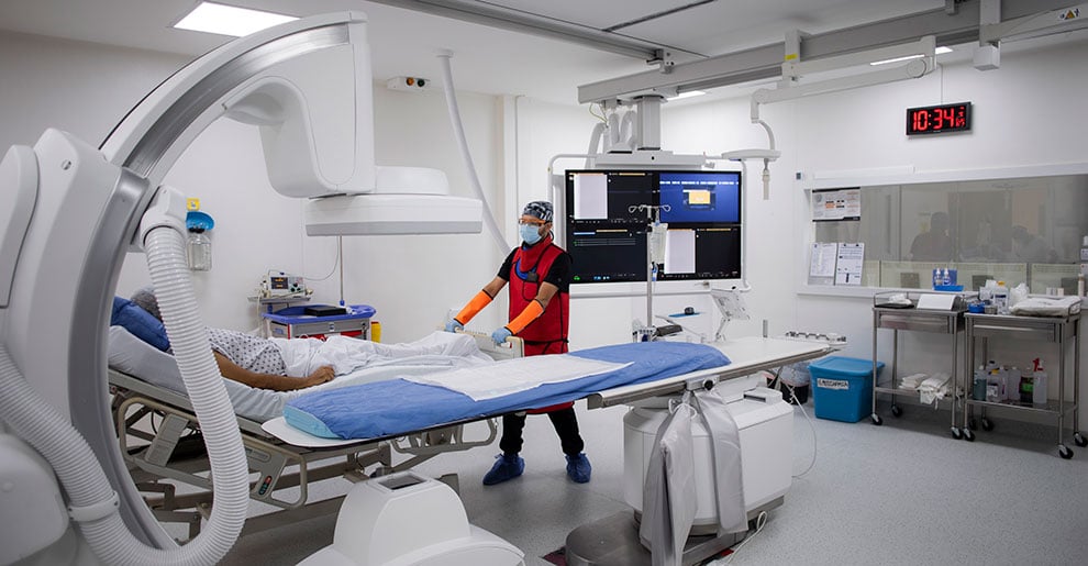 Radiologist helping patient into scanning machine